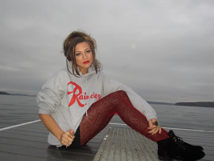 cassandra-mcclure-the-north-west-raincity-hoodie-seated-dock-puget-sound