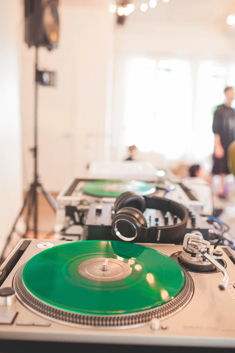 Turntable DJ setup at a wedding reception with headphones and PA speakers using a pair of Serato DJ Control Vinyl.