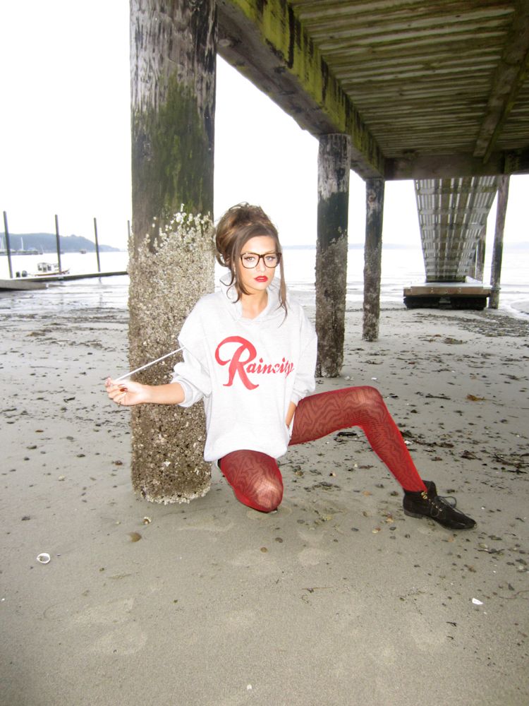 cassandra-mcclure-the-north-west-raincity-hoodie-seated-under-pier