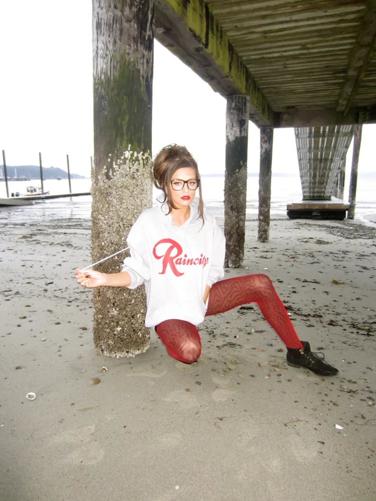cassandra-mcclure-the-north-west-raincity-hoodie-seated-under-pier