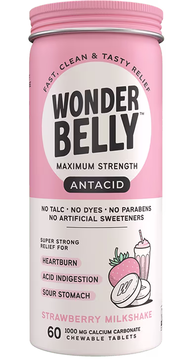 A Wonderbelly maximum strength antacid bottle labeled “Tropical Fruit,” listing fast and tasty relief for heartburn, acid indigestion, and sour stomach, with illustrated pineapple, mango, and orange on a peach‑colored label.