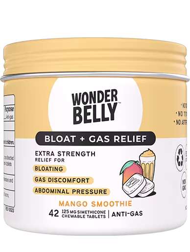 Close‑up of a Wonderbelly bloat and gas relief container labeled “Mango Smoothie,” highlighting extra‑strength relief for bloating, gas discomfort, and abdominal pressure, shown as a standalone product on a neutral background.