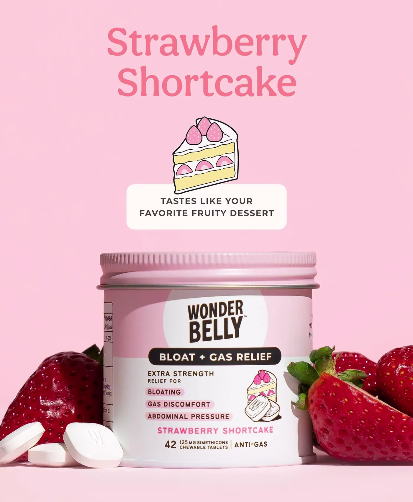 Wonderbelly bloat and gas relief jar labeled “Strawberry Shortcake,” surrounded by fresh strawberries and white chewable tablets on a pink background, with text reading “Strawberry Shortcake” and “Tastes like your favorite fruity dessert.”