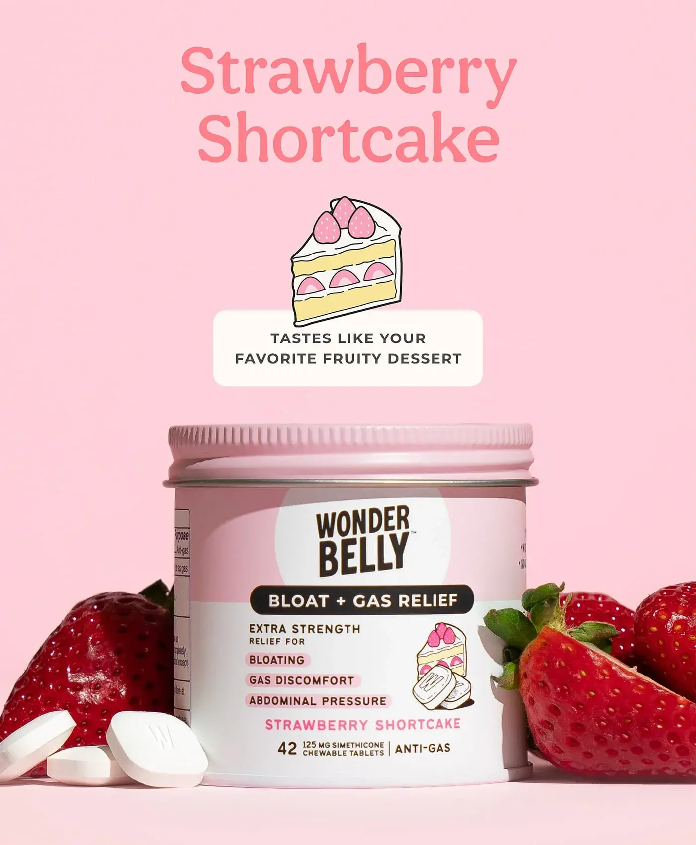 Wonderbelly bloat and gas relief jar labeled “Strawberry Shortcake,” surrounded by fresh strawberries and white chewable tablets on a pink background, with text reading “Strawberry Shortcake” and “Tastes like your favorite fruity dessert.”