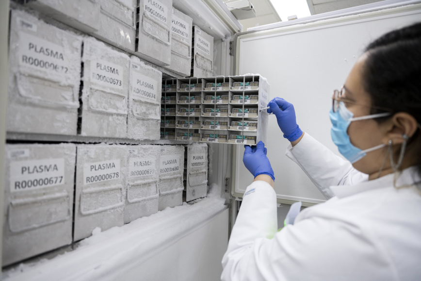 Scientist pulling samples out of cold storage