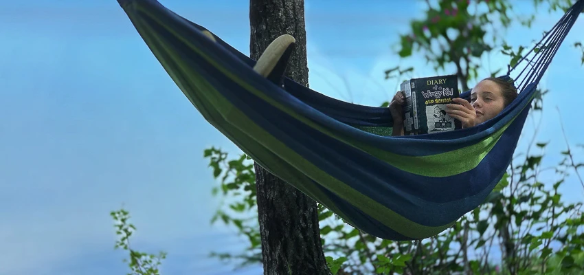 Child summer reading in a hammock