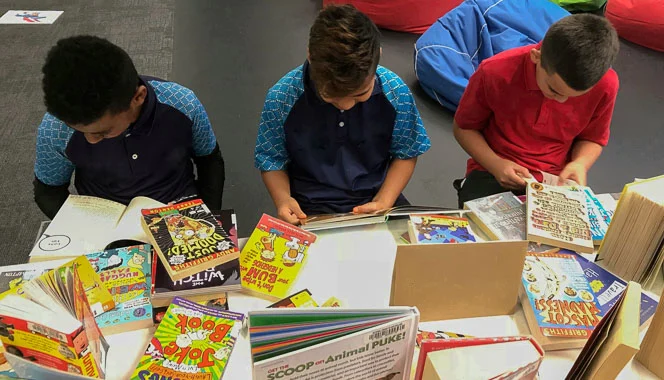 Boys selecting books to read.