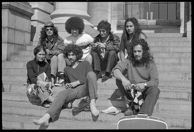 Black and white image of members of Nga Tamatoa on Parliament steps in 1970s clothing and hairstyles