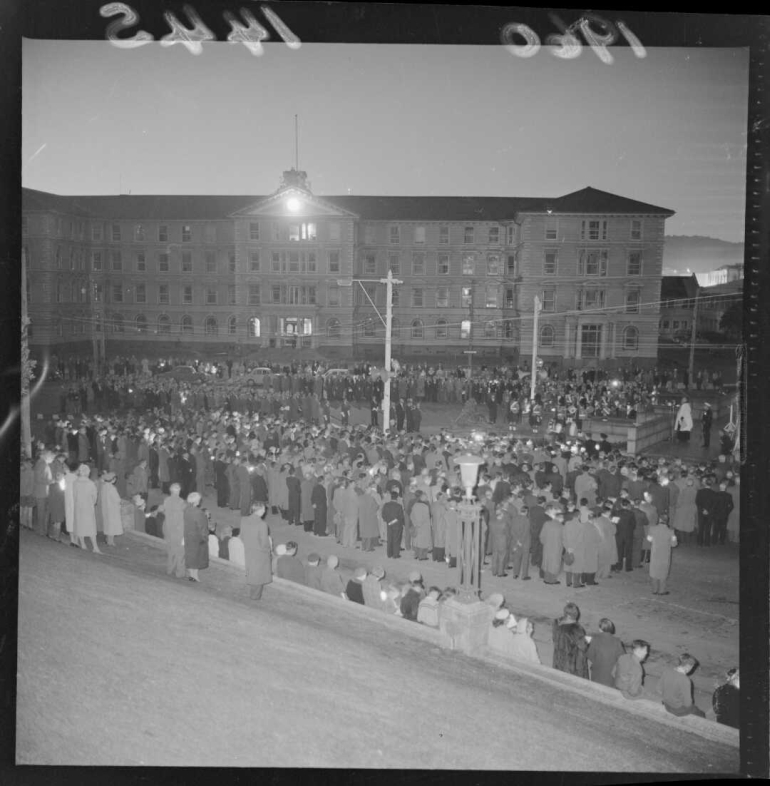 Shows a large group standing in the dawn light for the morning ceremony.