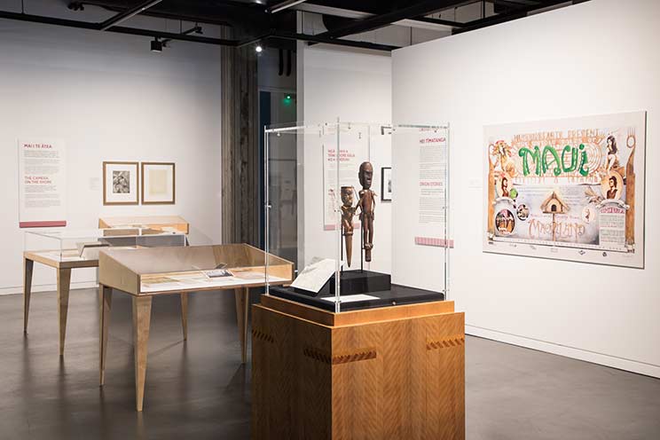 A gallery view of Pūkana showing various cases and framed images on the walls.