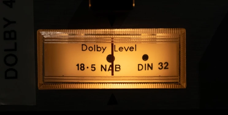 A Dolby level indicator that is Illuminated from within with a soft yellow light.