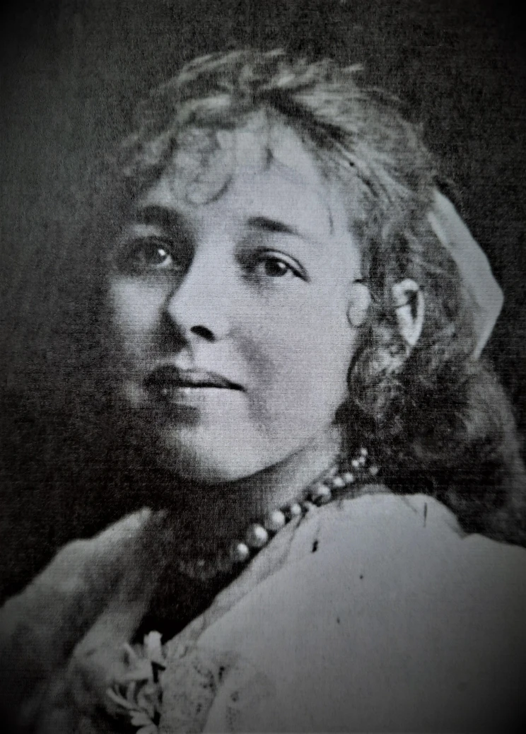 A black and white portrait showing a woman wearing pearl necklace.