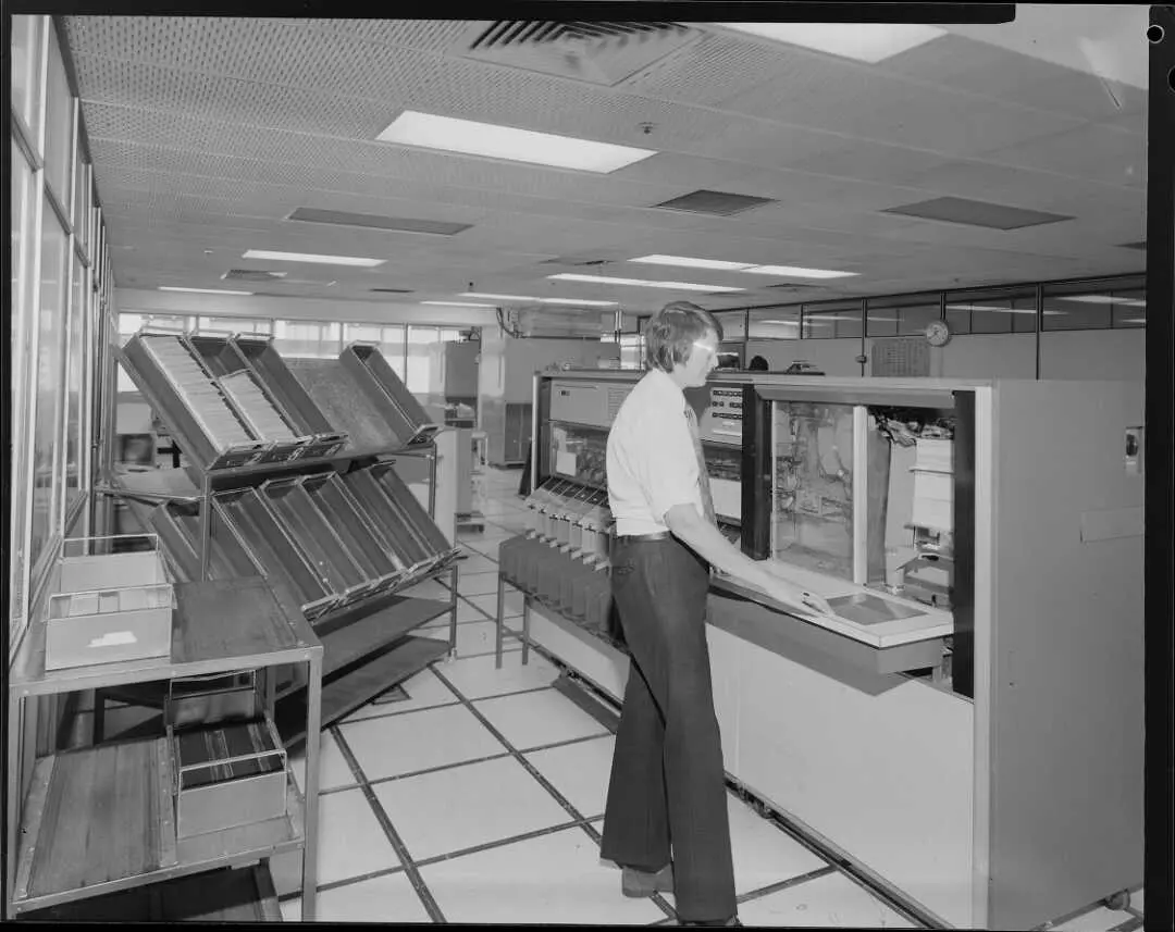 Man operating large computer, 1975.