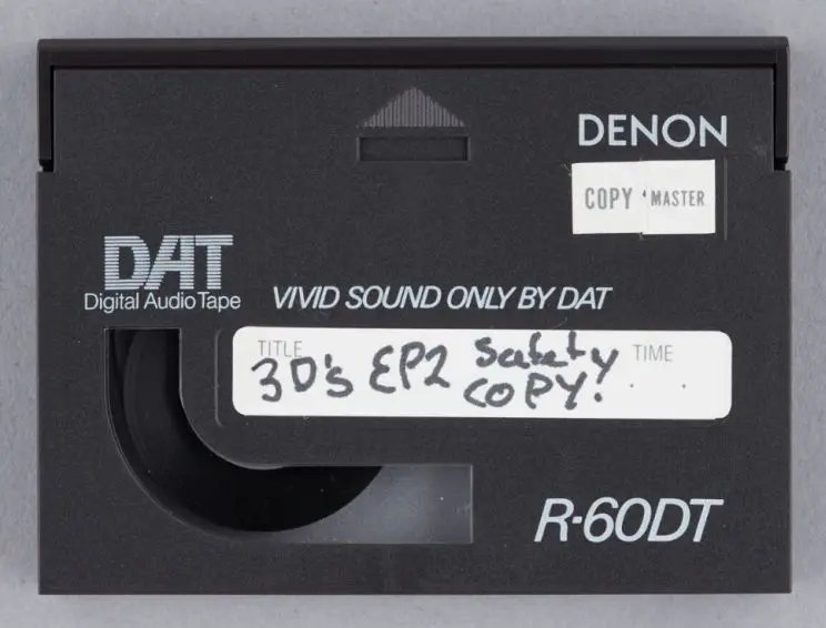 An example of a DAT with a the words 'Copy Master' on the outside and handwritten label showing what is contained on the tape. 