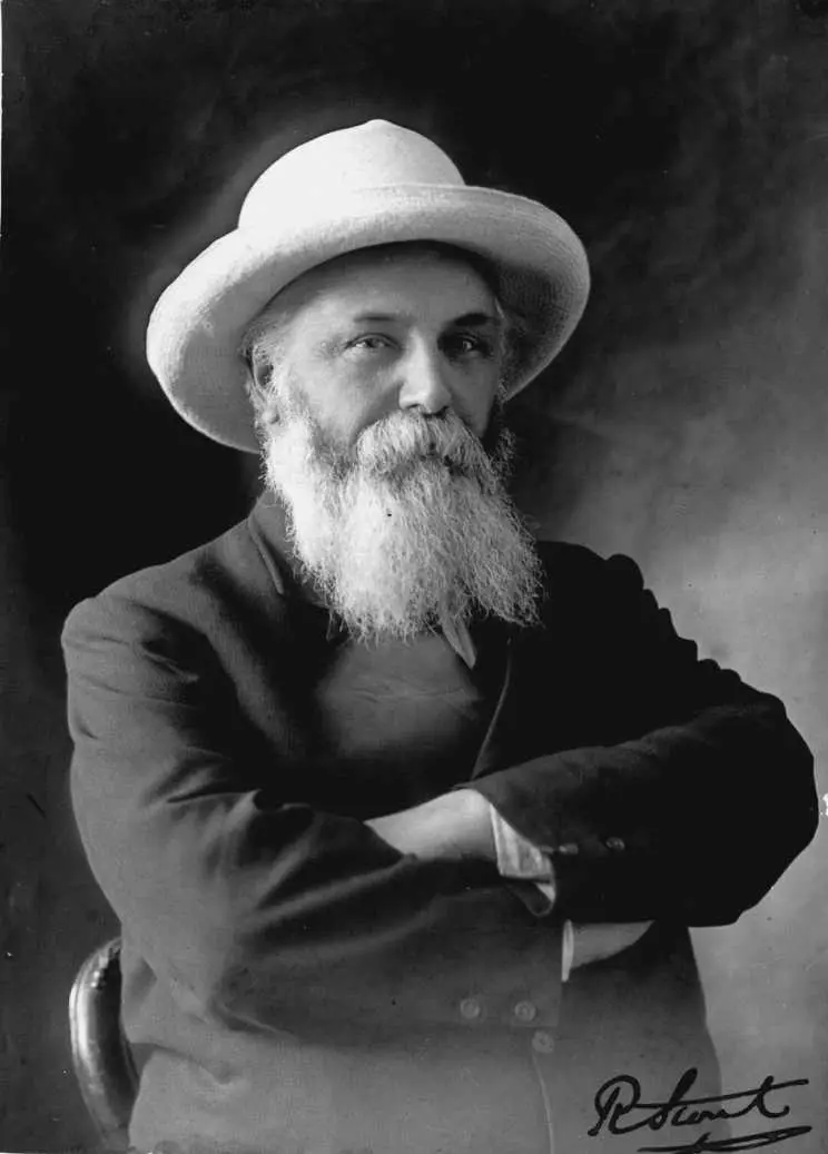 Robert Stout, behatted and with arms crossed, circa 1919.