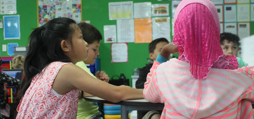 Young children learning in a classroom.