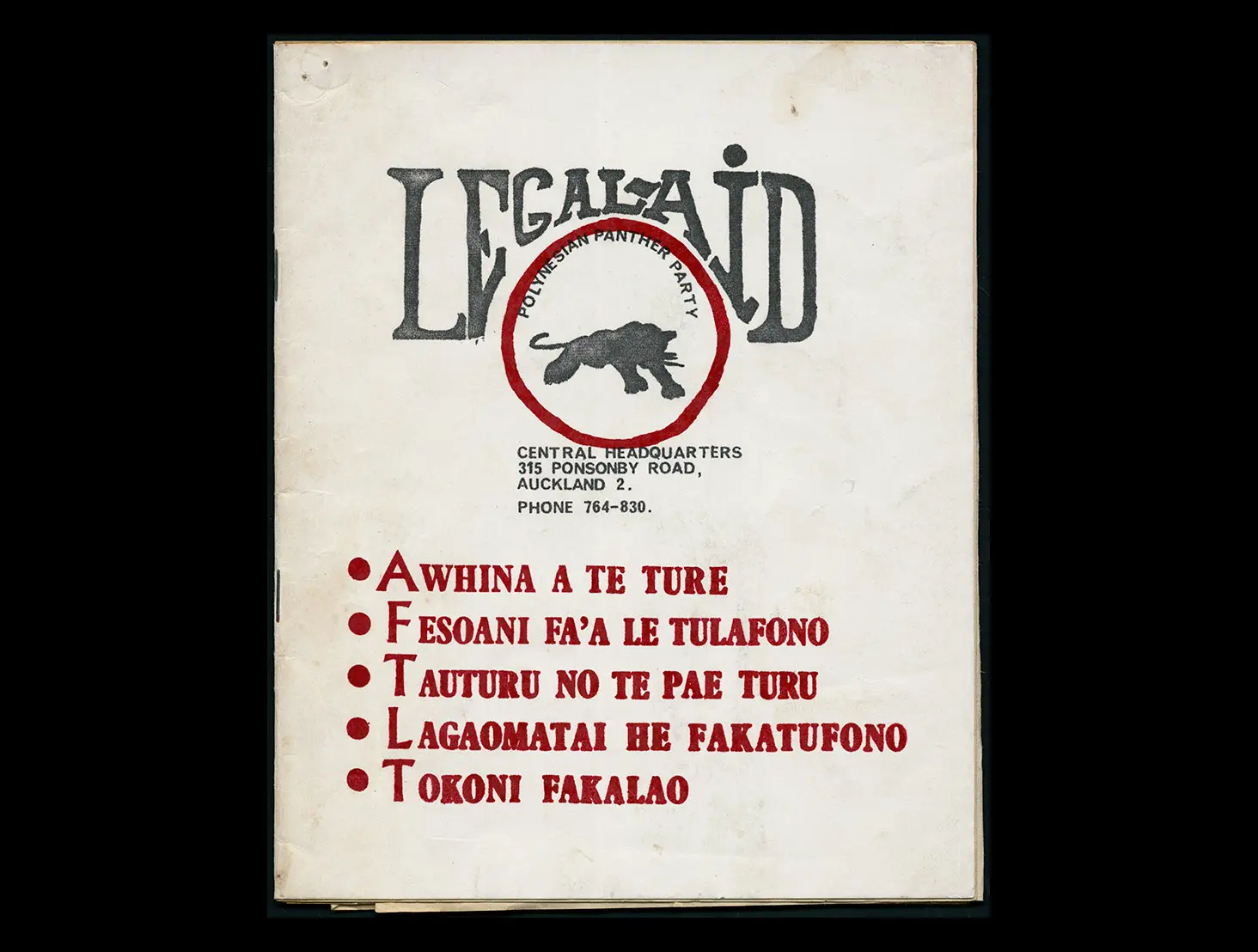 Colour photo showing the cover of a legal aid booklet for the Polynesian Panther Party. It shows their logo (a black panther) and headings in different Pacific languages such as 'Awhina a te ture'.