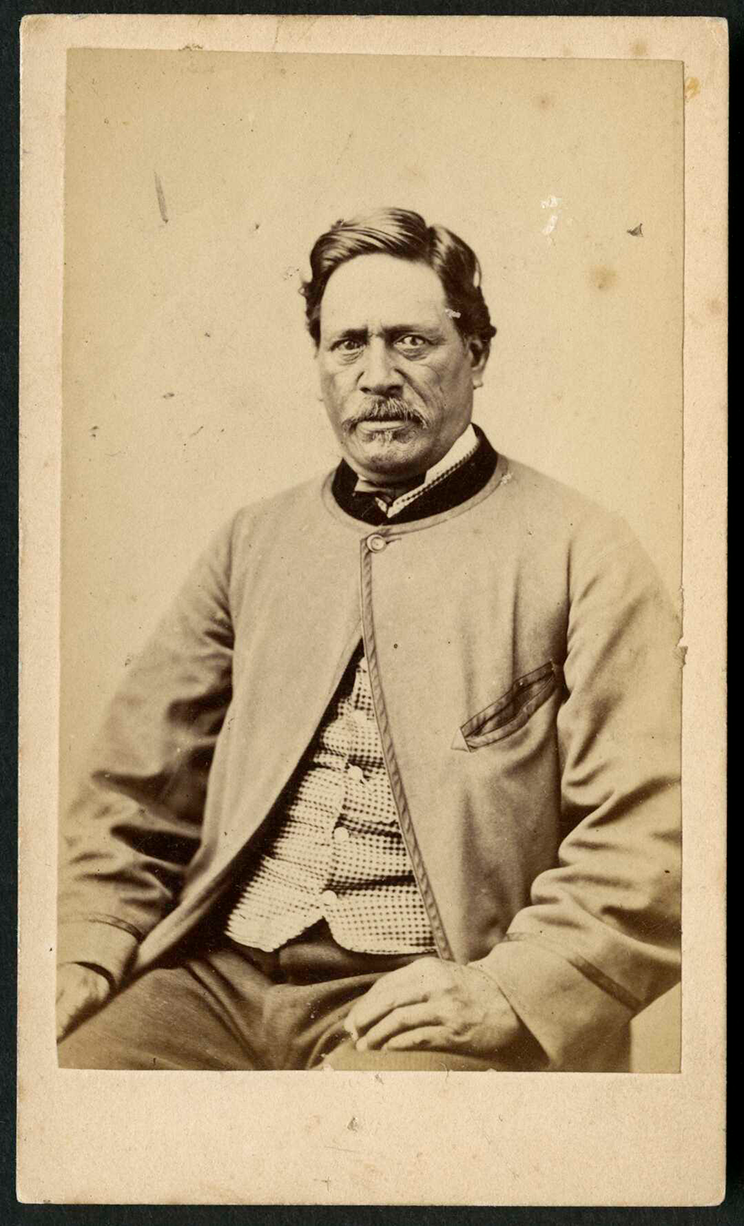 Sepia portrait of a Māori man wearing Victorian clothing. 