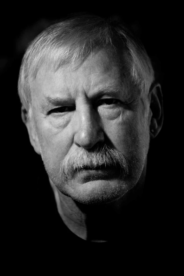Black and white portrait of a man with a serious expression.