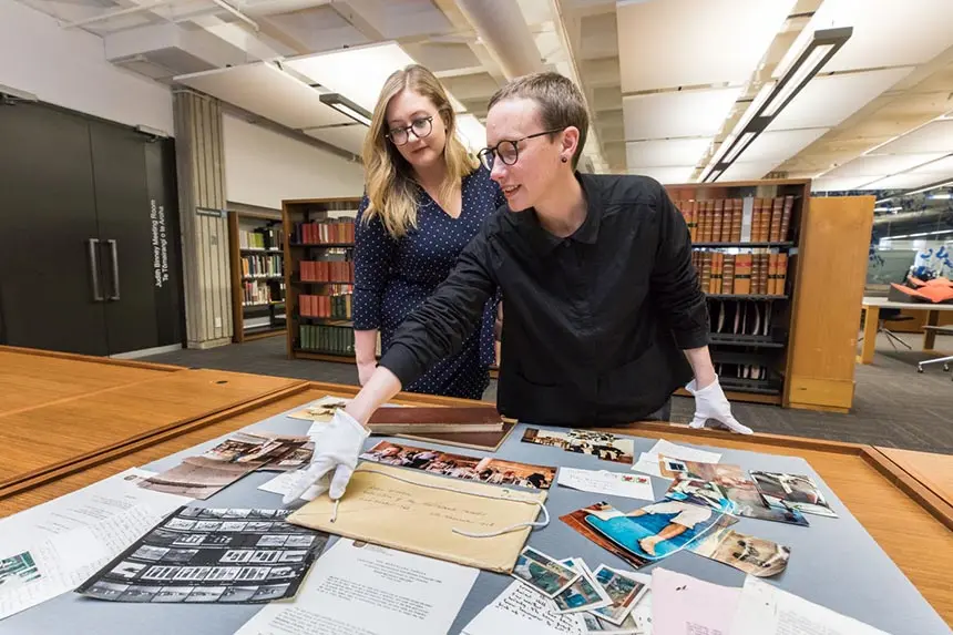 Library staff looking at the material from the archive.