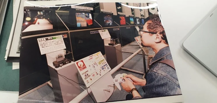 A boy holding a joystick appears to play a video game.