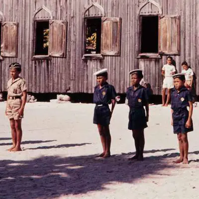People standing at attention in front of a church