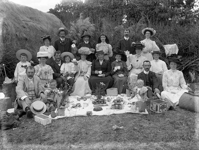 A large group of men, women and children at a picnic