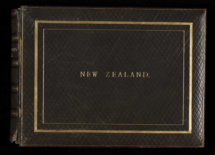 Dark green leather bound photo album cover with the words "New Zealand".