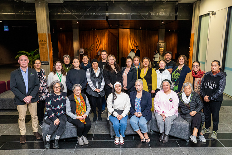 Group photo of Māori men and women at the National Library Te Puna Mātauranga o Aotearoa.