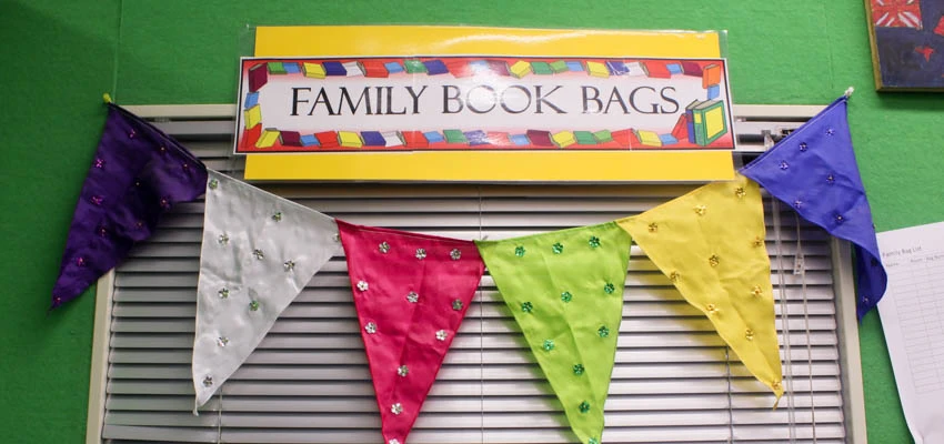 Coloured flags under a sign with the words'family book bags.