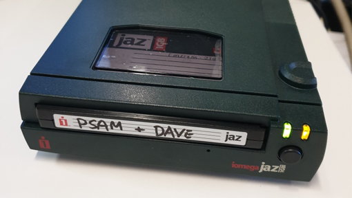 A Jaz drive with Jaz disk being read as indicated by two small lights illuminated on the front.