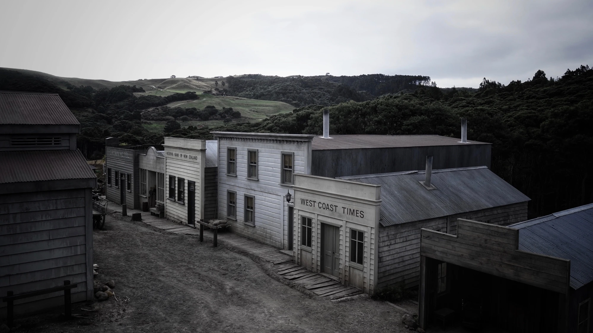 Completed set viewed from the second story, with wooden buildings along a muddy street.