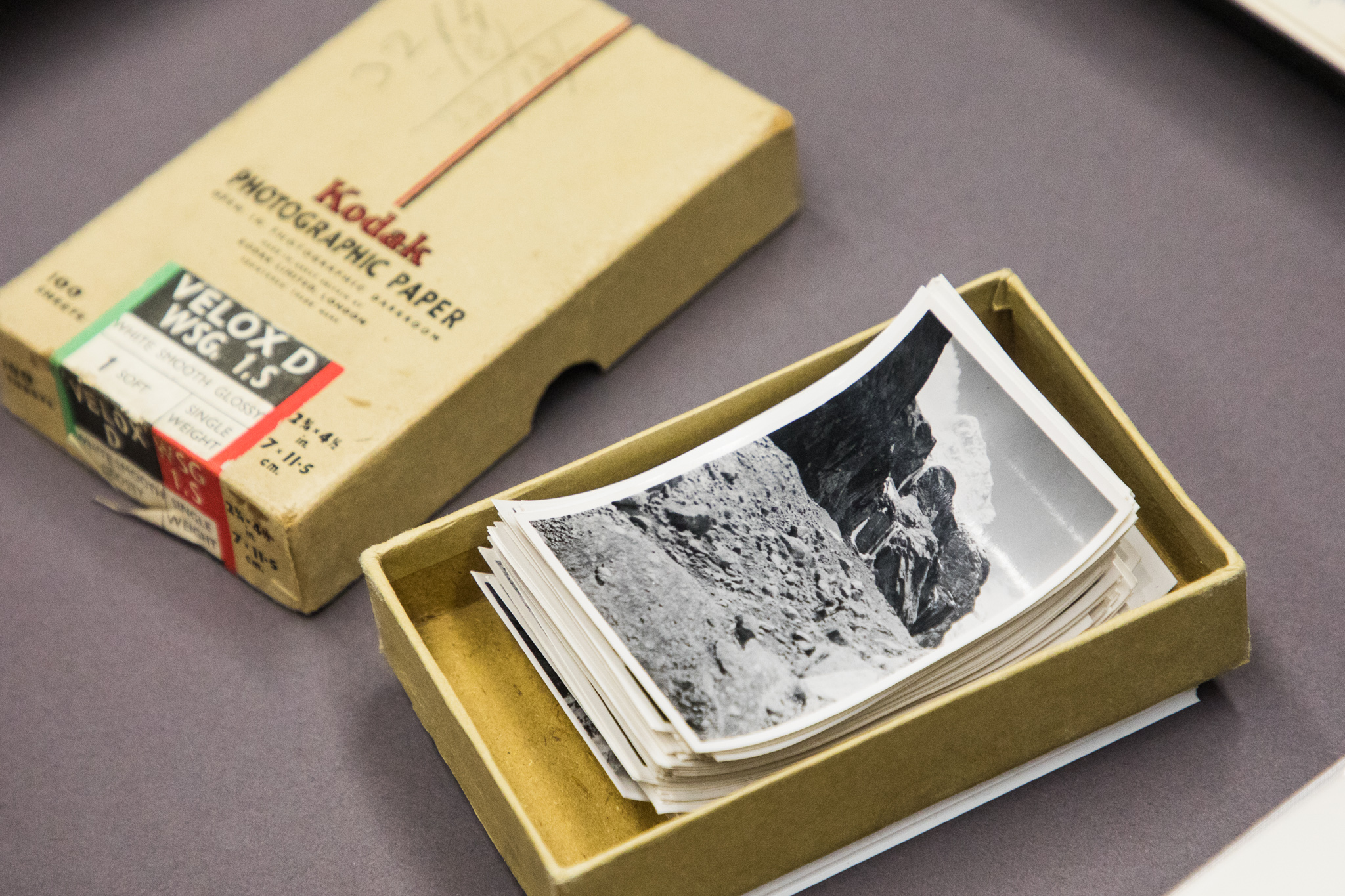 Shows a small box of black and white photographs.