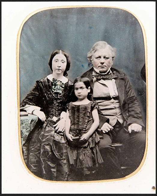 Studio ambrotype photograph of William, his wife, and daughter. See Description below.