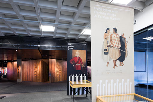 Two banners on display in a foyer - one with an image of Hone Heke, Hariata Rongo and Te Ruki Kawiti, and one with Lt-Col Cyprian Bridge.