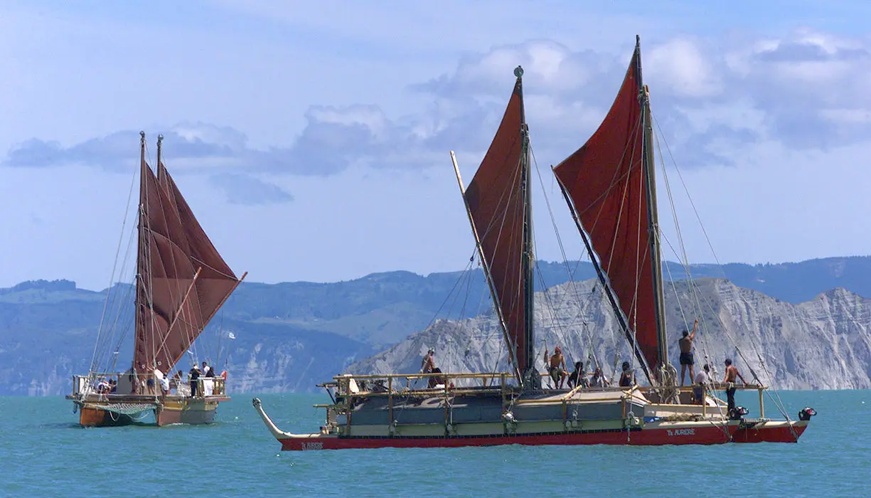 Colour photograph of 2 waka (Te Au-o-Tonga and Te Aurere) with crew on board sailing in Poverty Bay.