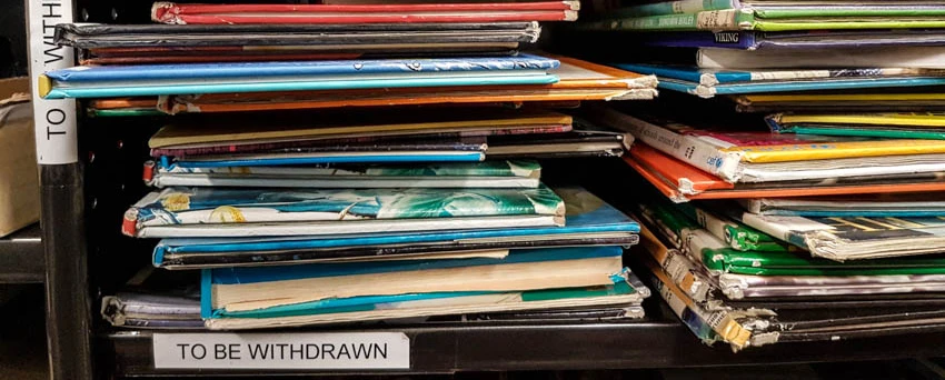 Withdrawn books on a school library shelf.