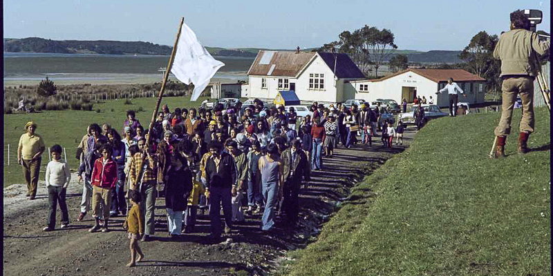 People on Māori Land March leaving Te Reo Mihi Marae, Te Hapua, with a man videoing them.