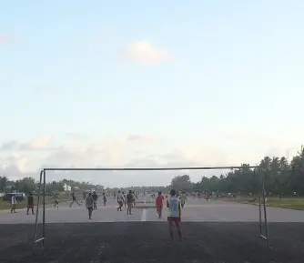 After work football on a runway.