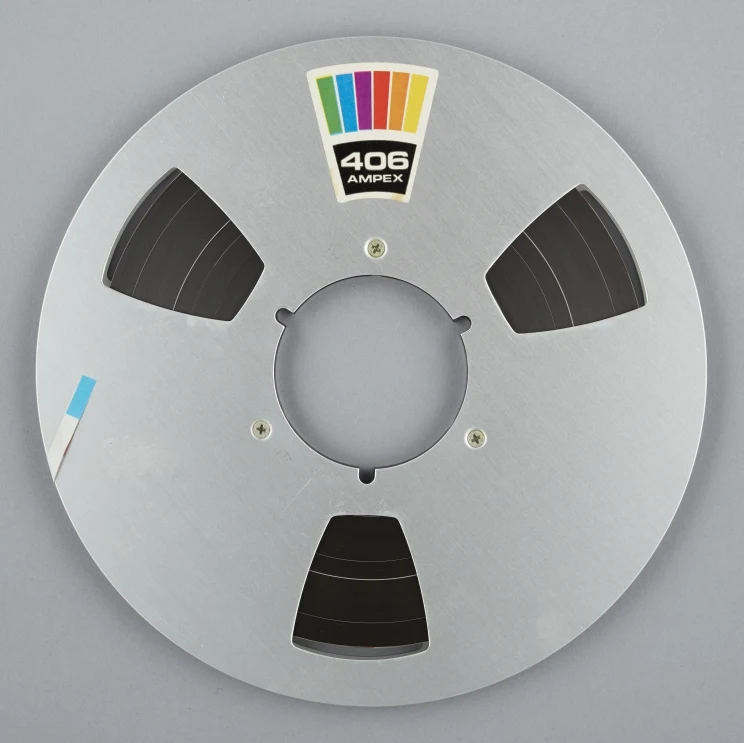 A reel of magnetic tape with the label '406 Ampex'.