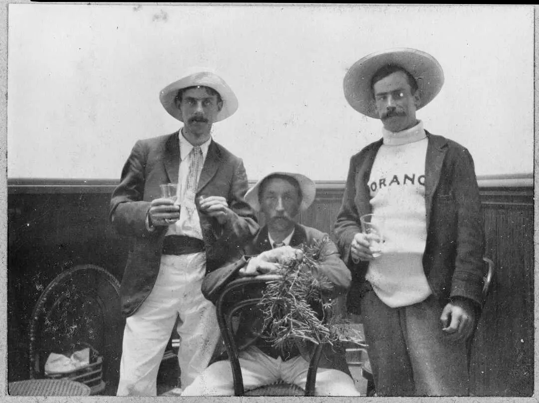 Three men wearing costumes posing for a group portrait.