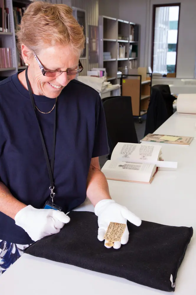 Curator of the Rare Book Collection, Ruth Lightbourne, with the newly-acquired hornbook in her hand.