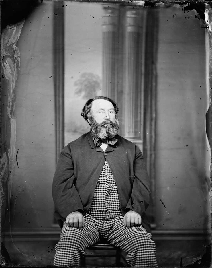 Victorian era photo of a man in a checked suit. 