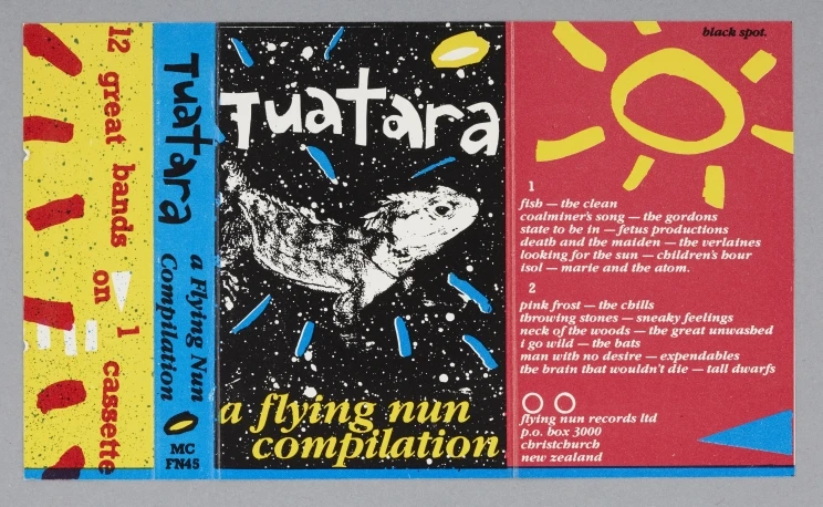 The inside of the paper insert shows a blue, red, yellow and black album cover with a tuatara and other graphics and words.