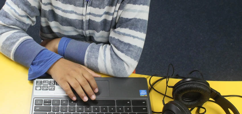 Student using a laptop in the classroom