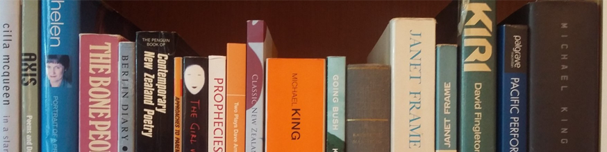 Tops of colourful books on a bookshelf.