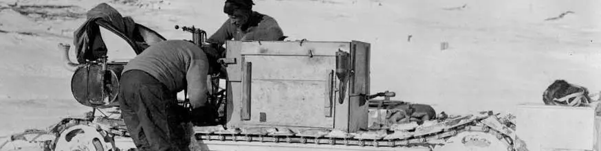 Two men fixing a mechanical sled. 