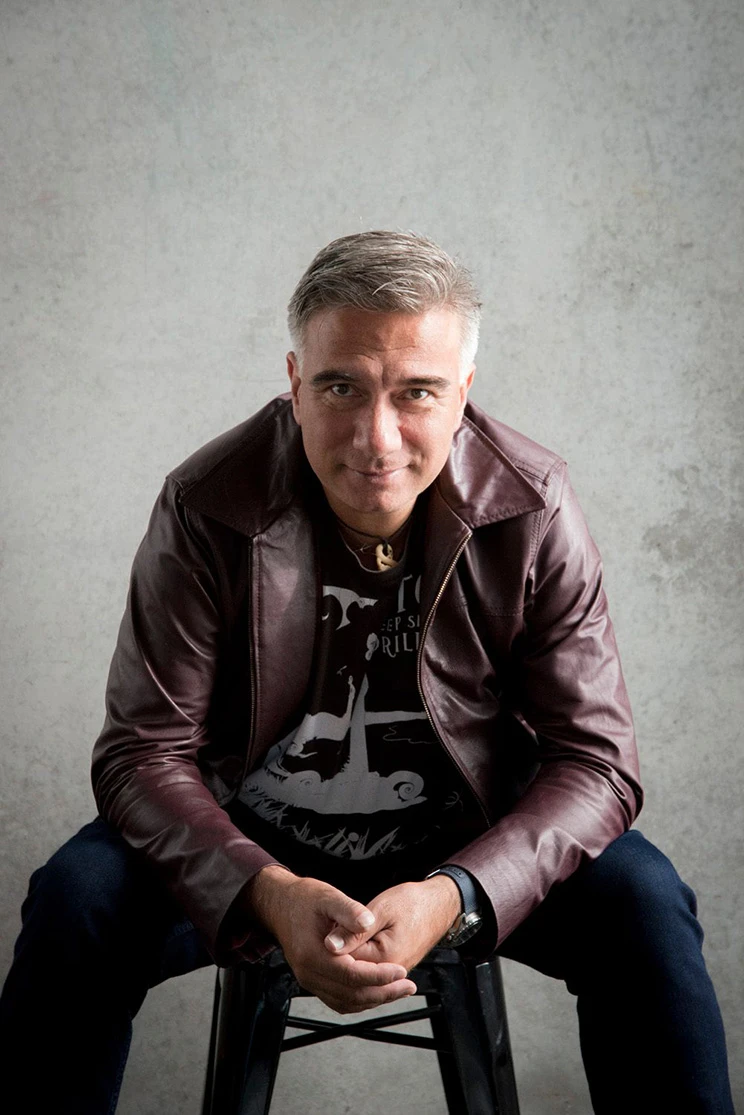 A casual portrait of Maōri man wearing a leather jacket and black t-shirt.