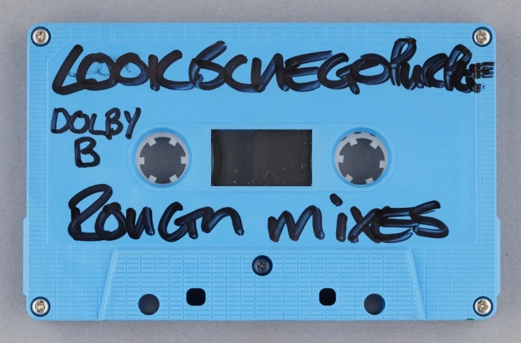 A close-up of the blue cassette with the words, 'Look blue go purple' and 'rough mixes' written on outside in black ink.
