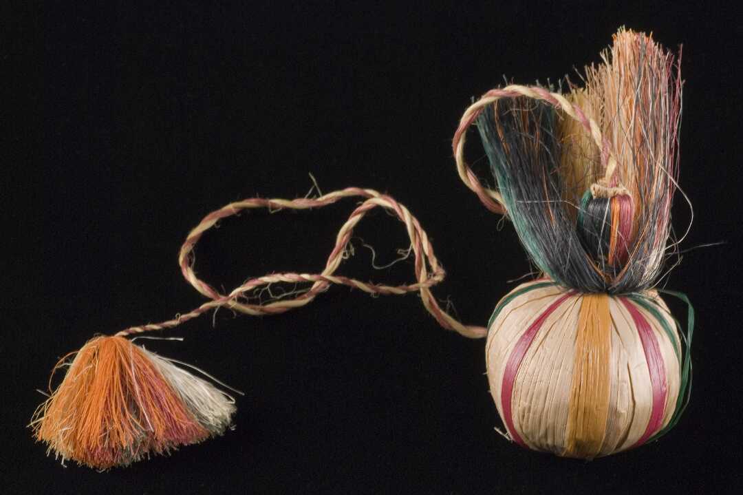 Poi with coloured stripes and long plaited, fringed tassel.